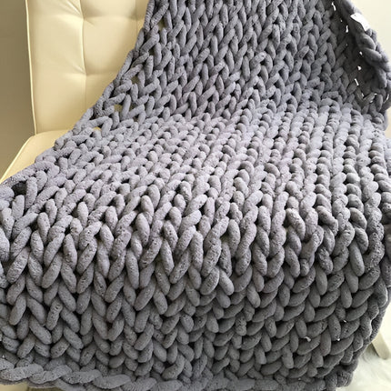Chunky Knit Throw Blanket draped over a bed – image 4