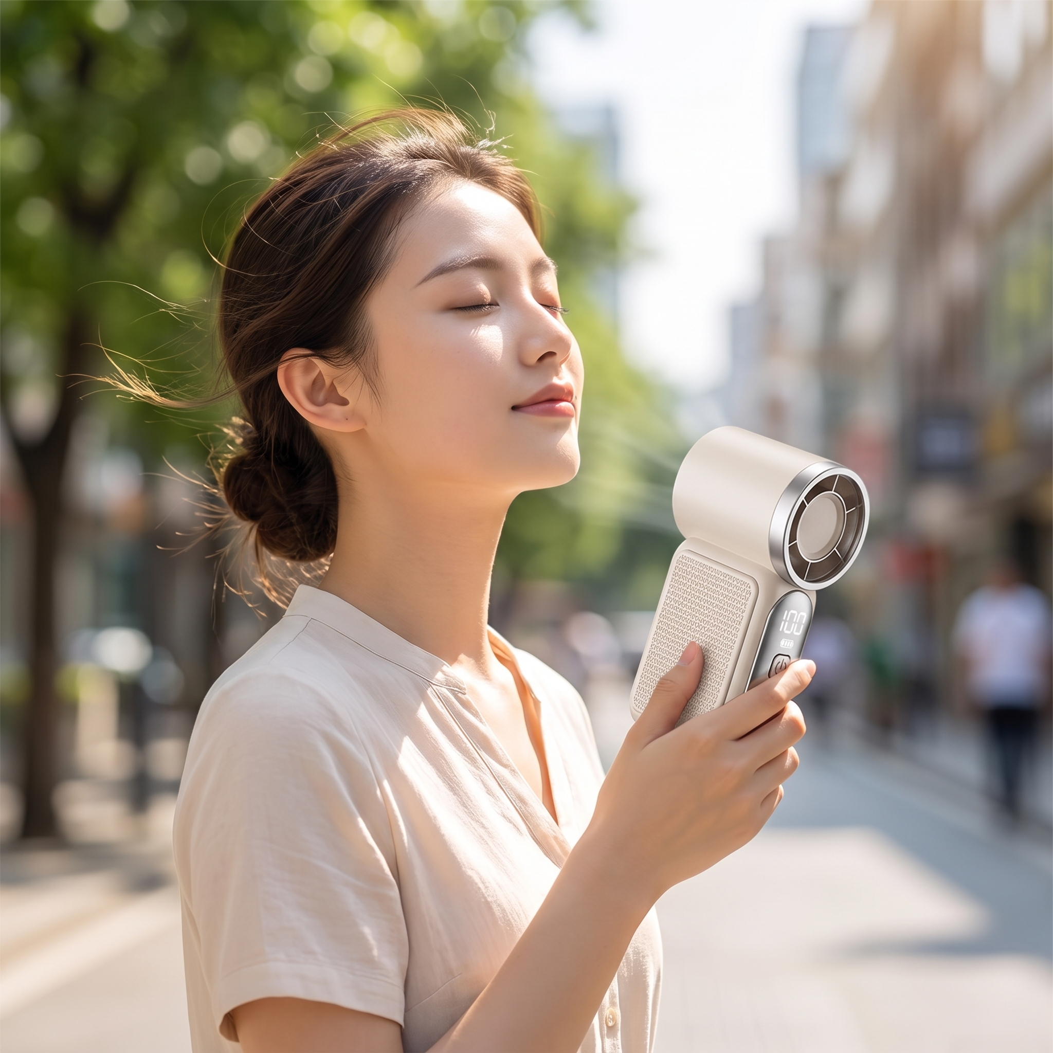 Woman cooling off with the portable rechargeable handheld fan outdoors