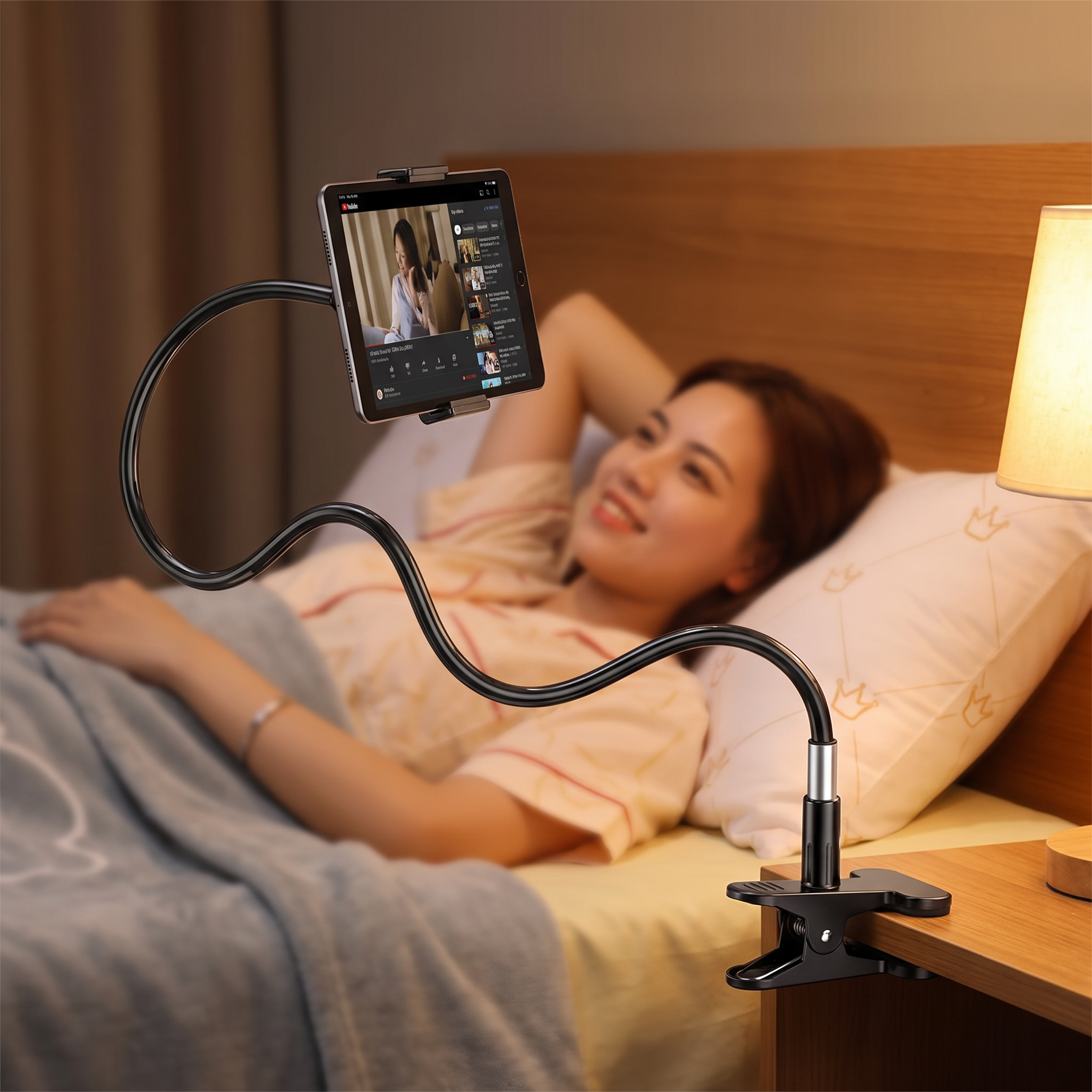 Adjustable tablet holder stand mounted at a bedside