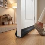 Door draft stopper fitted at the base of a door